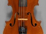 a close up of a violin with a bow on a gray background