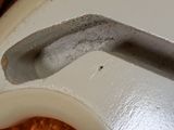 a close up of a white guitar with a hole in the neck