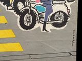a poster on the side of a building with a man on a motorcycle