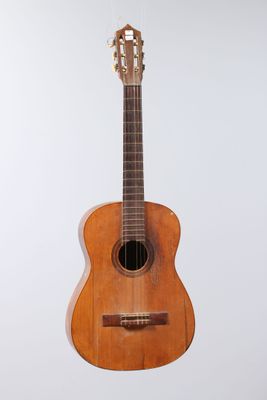 a close up of a wooden guitar on a white background