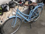 a blue bicycle parked next to a pile of boxes