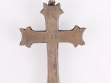 an antique silver cross on a white background