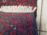 a red and black rug on the floor next to a black and white rug