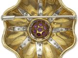 an image of a gold and purple flower broochle on a white background