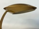 a gold lamp that is on top of a table