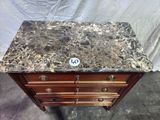 an antique marble top chest of drawers with a number on the top