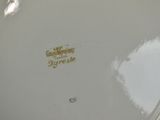 a white plate with a gold writing on it