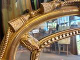 a gold frame with a picture of a horse on it