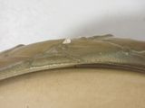a close up of a metal object on a white surface