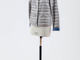 une veste grise posée sur un mannequin, sur fond blanc