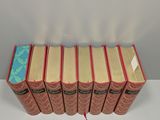 six books are stacked on top of each other on a table
