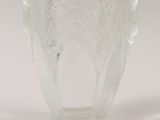 a clear glass vase with a tree design on it