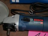 a bosch electric drill on a table next to other tools