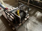 a man standing next to a winch on a pallet in a warehouse