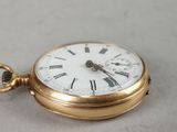 a gold pocket watch with roman numerals on it