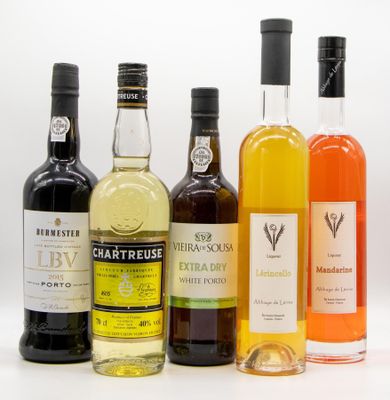 several bottles of alcohol are lined up on a white surface