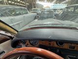 dashboard view of a car driving down a busy street in the rain