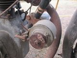 a close up of an old motorcycle with a rusted engine