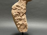 a stone sculpture of a man ' s head on a black base