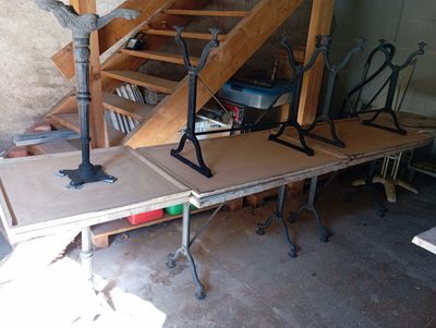 several pieces of wood sit on top of a table in front of a set of stairs