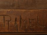 a close up of a wooden box with a name carved into it