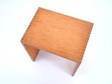 a small wooden table with a wooden top on a white surface
