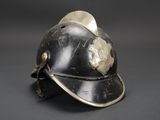 an old fireman ' s helmet on a grey background