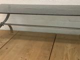 a glass table with a metal base on a wooden floor