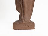 statue of a woman with a veil on her head and a book in her hand