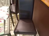 two chairs that are next to a table in a restaurant