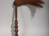 a wooden stick with a long brown hair on top of it