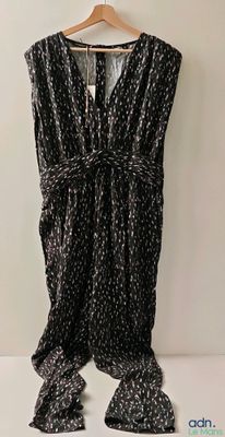 the black and white dress is hanging on a hanger