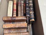 a box full of old books sitting on a table