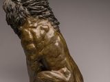 bronze sculpture of a lion sitting on its hind legs