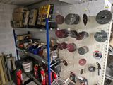 many different tools on the shelves in the garage