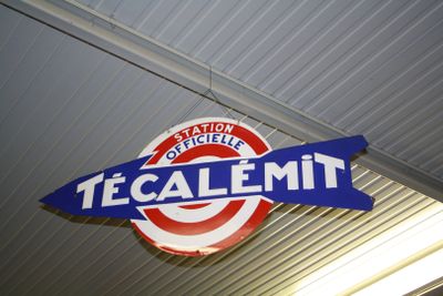 a sign that says tecalemit hanging from the ceiling