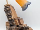 a lamp that is sitting on top of a pile of books