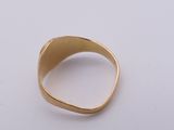 a close up of a gold ring on a white surface