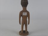 wooden figurine of a man with a name tag on his chest