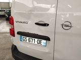 a white van parked in a parking lot with other cars