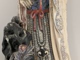 an image of a statue of a woman with a flower in her hand