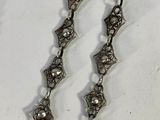 pair of antique silver plated necklaces with pearls on a white background
