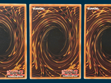 three cards that have a picture of a black hole in them
