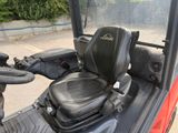 a black seat on the back of a red utility vehicle