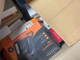 a cardboard box with a black and orange tool inside of it