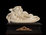 an image of a statue of a woman laying on top of a marble base