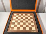 an orange and black box with a chess board inside of it
