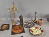 a table with various items on it including a candle, a plate, a plate of food, and a candle holder