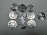 six different types of silver coins are shown on a table