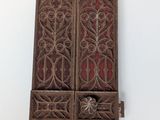 pair of antique carved wood window shutters with red glass panels